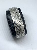 Bracelet rolled to show full width and textured links