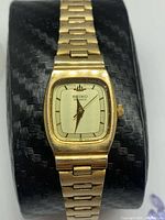 Front view of Seiko gold-plated ladies quartz watch on display cushion