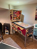 Full view of Playmatic Fiesta pinball machine, cabinet side art, metal legs