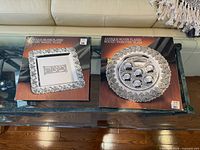 Both boxed plates on glass table