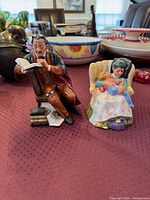 Both Royal Doulton figurines on display