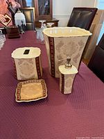 Four bathroom accessories displayed on table