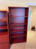 Front view of the empty reddish-brown 6-shelf bookcase
