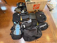 All twelve bags laid out on hardwood floor