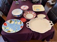 All eight ceramic pieces displayed on table