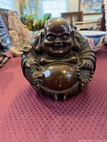 Front view of hollow-cast bronze Maitreya Buddha statue