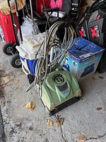 Front angled view of Hayward AquaVac Pro cleaner with coiled cord