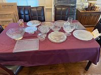 Entire lot on dining table showing all glass and crystal pieces
