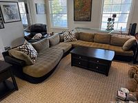 Sectional sofa showing cushions, base, arms and throw pillows