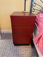 Front view showing three drawers and finish