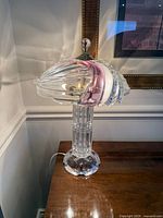 Full view of crystal lamp on table showing shade, stem and base