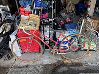 Left side profile of red Supercycle 1220 women’s road bike showing frame, wheels, handlebars and drivetrain