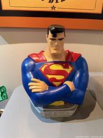 Front view of Superman bust showing chest emblem and folded arms