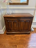Front and side view of Thomasville mahogany server cabinet showing doors and plinth base
