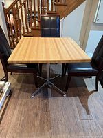 Top view of square wood table with metal pedestal base