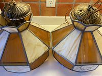 Both stained glass pendant lights side by side showing overall design and ceiling caps