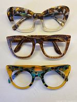 All three eyeglass frames laid out vertically