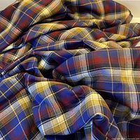 Unfolded wool plaid fabric showing overall yardage
