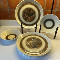 Group view of four plates and two bowls showing pattern and condition