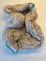 Full view of the oversized ecru raw silk skein