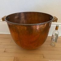 Full view of cauldron with bottle for scale