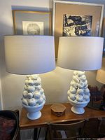 Front view of both white ceramic fruit lamps with shades