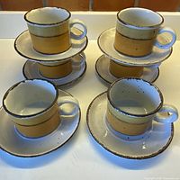 Six cup and saucer sets displayed