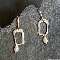 Full view of both earrings showing design and condition