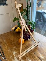 Full view of hardwood tabletop easel in standing position