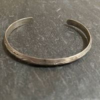 Top view of entire cuff showing concave shape and etched pattern