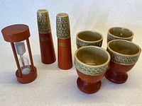 Complete set: salt and pepper shakers, egg timer, four egg cups