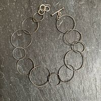 Full view of bracelet showing alternating circle links and toggle clasp