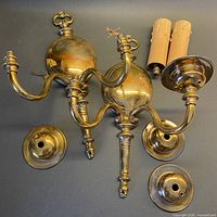 Pair of brass sconces, two mounting plates, two candle sleeves