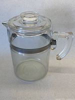 Full view of clear glass Pyrex teapot with lid attached