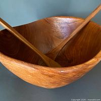Overall view of teak bowl with utensils inside