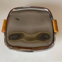 Top view of reflective stainless steel square tray with Bakelite handles