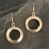 Front view showing both earrings and circular open-center design