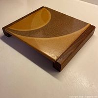 Perspective view of ceramic tile hotplate showing walnut rails and tile surface