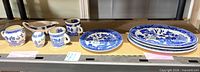 Full lot showing platters, round plates, mugs, creamer, gravy boat, sugar bowl