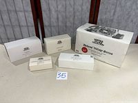 Five Department 56 boxes displayed together