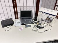Overview showing portable DVD player, Onn DVD player, remote, cables, manual, box