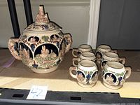 Full view of lidded stein with six mugs