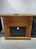 Full view of fireplace with remote on mantel top