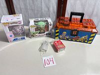 Group view of all items: two Funko Pop boxes, Bob the Builder toolbox, LED string lights, tea lights