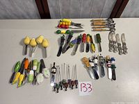 Entire lot laid out showing all spreaders, bamboo servers, cocktail picks and violin-handle knives