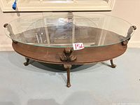 Full view of oval wood and glass coffee table