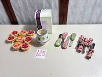 Group shot of all items: warmers, boxed Scentsy Tea Rose, eight tart toys, nine spreaders