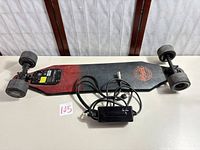 Full view of longboard underside with charger present
