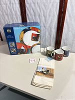 Boxed dinnerware set, three extra mugs, kitchen towel