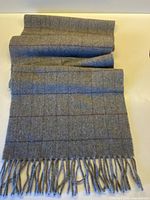 Full length view of grey wool scarf with fringe